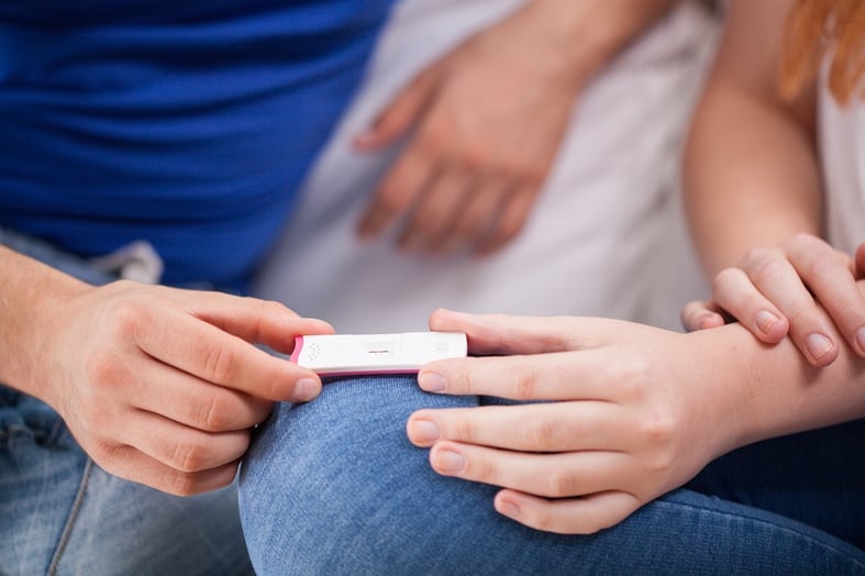 Future parents with positive pregnancy test, horizontal.jpeg