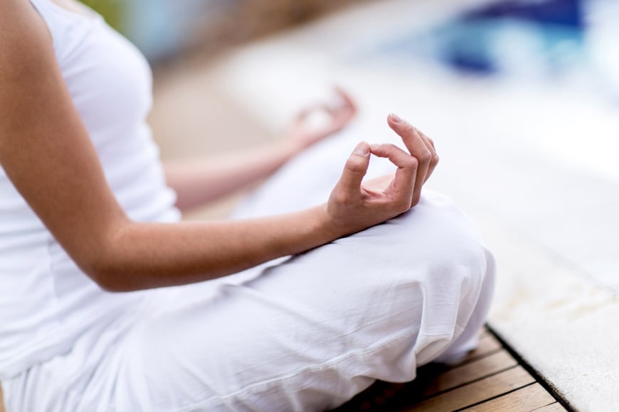 Yoga woman meditating and making a zen symbol with her hand-1.jpeg